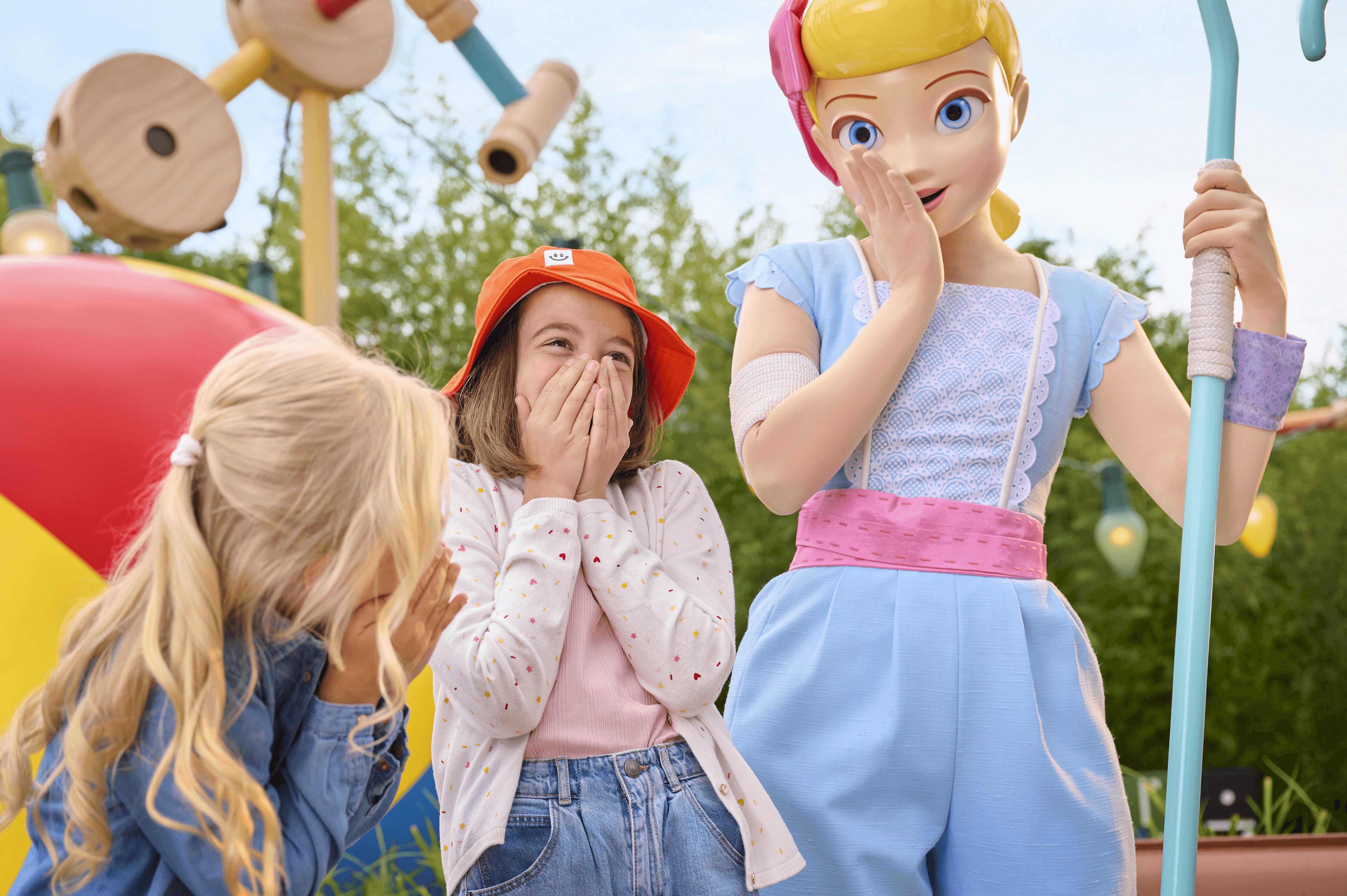 Two children sharing a joyful moment with Bo Peep from Toy Story at Walt Disney Studios® Park
